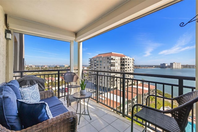 balcony featuring a view of city and a water view