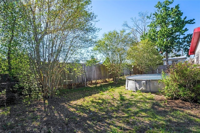 view of yard featuring a fenced in pool and fence