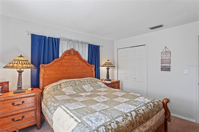 carpeted bedroom with a closet, visible vents, a textured ceiling, and baseboards