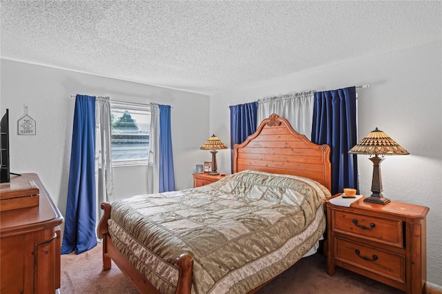 carpeted bedroom featuring a textured wall and a textured ceiling