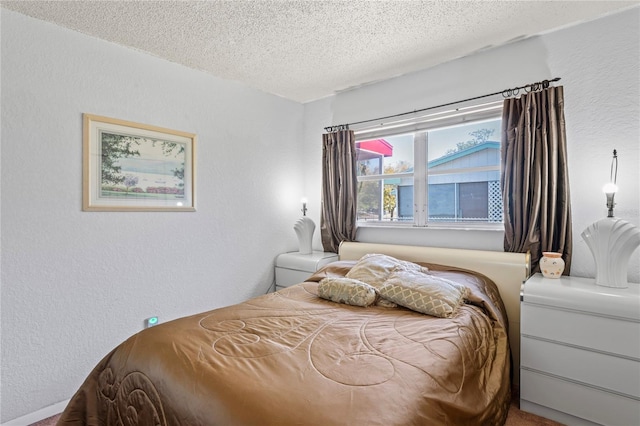 bedroom featuring a textured ceiling and a textured wall