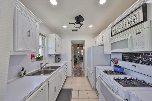 kitchen with visible vents, light countertops, white appliances, white cabinetry, and a sink