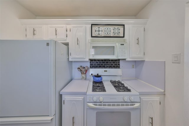 kitchen featuring white cabinets, white appliances, and light countertops