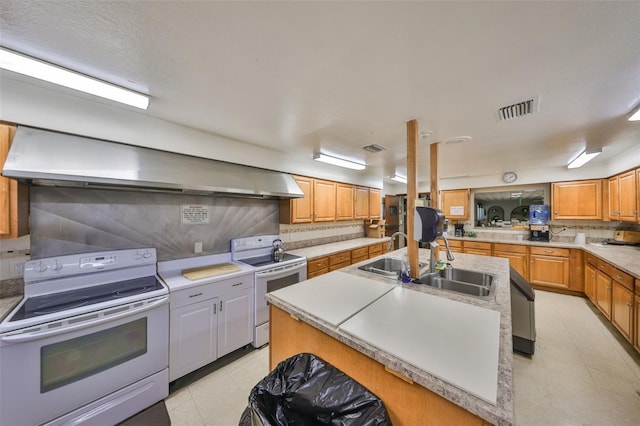 kitchen with a sink, wall chimney exhaust hood, visible vents, and white range with electric stovetop