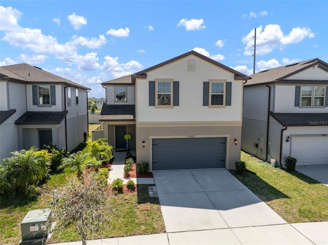 traditional-style home featuring concrete driveway and an attached garage