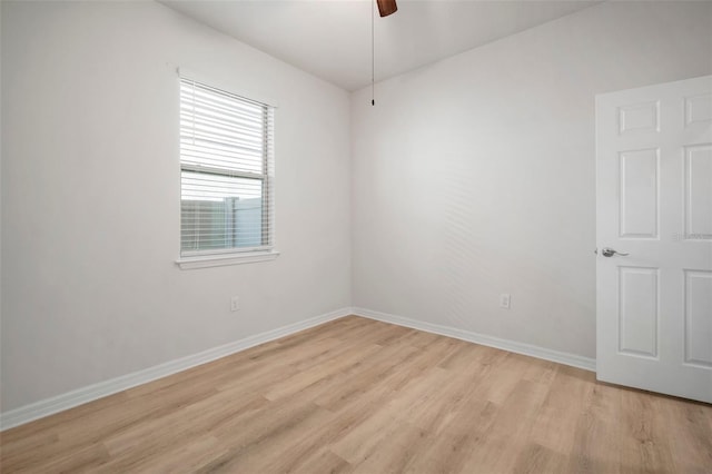 empty room featuring ceiling fan, baseboards, and light wood-style flooring