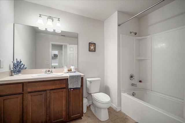 full bath featuring vanity, a textured ceiling, tile patterned floors, toilet, and shower / bathtub combination