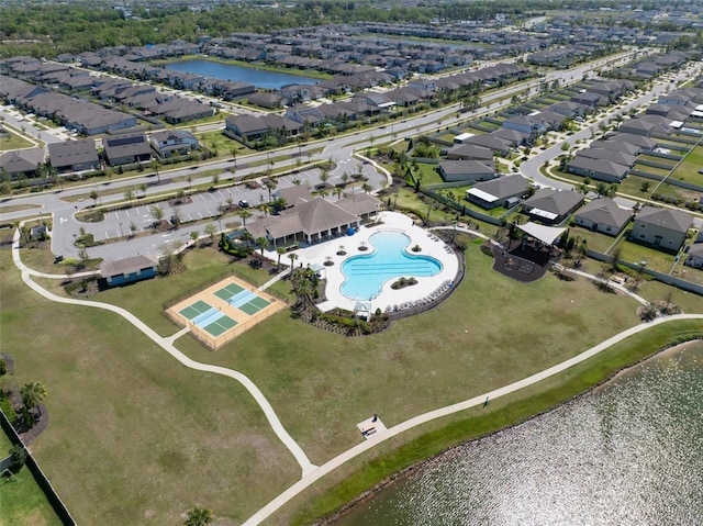 drone / aerial view featuring a residential view and a water view