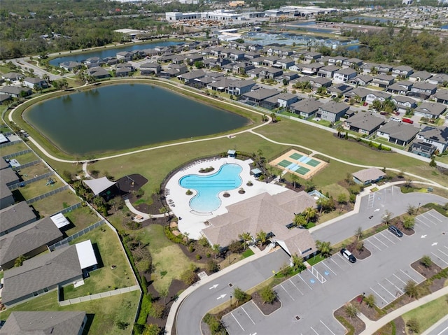 drone / aerial view with a residential view and a water view