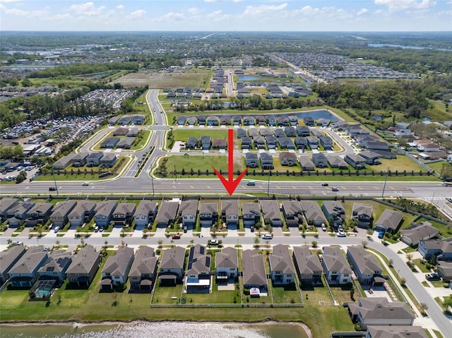 birds eye view of property featuring a residential view and a water view