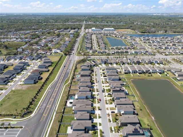 drone / aerial view with a water view and a residential view