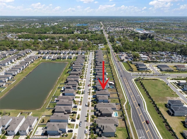 birds eye view of property with a residential view and a water view