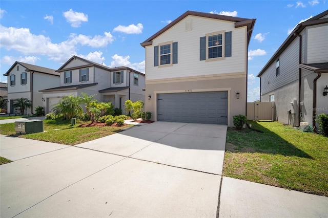 view of front of home with a front lawn, a garage, and driveway