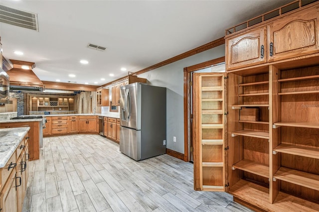kitchen with crown molding, island exhaust hood, visible vents, and appliances with stainless steel finishes