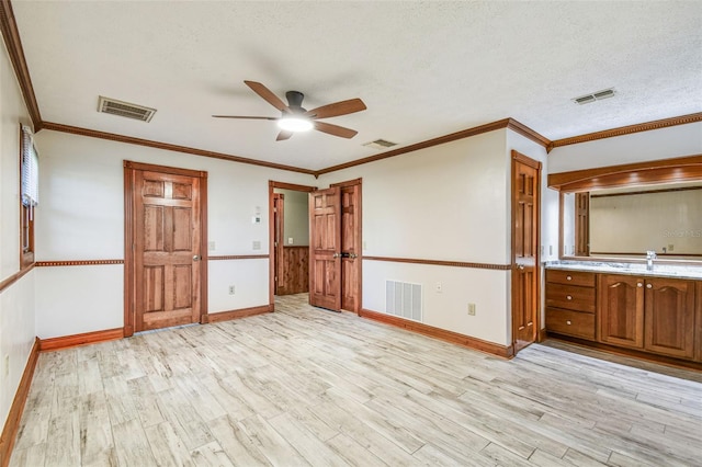unfurnished bedroom featuring light wood-style floors and visible vents