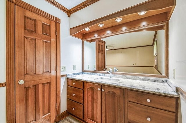 bathroom with vanity and crown molding