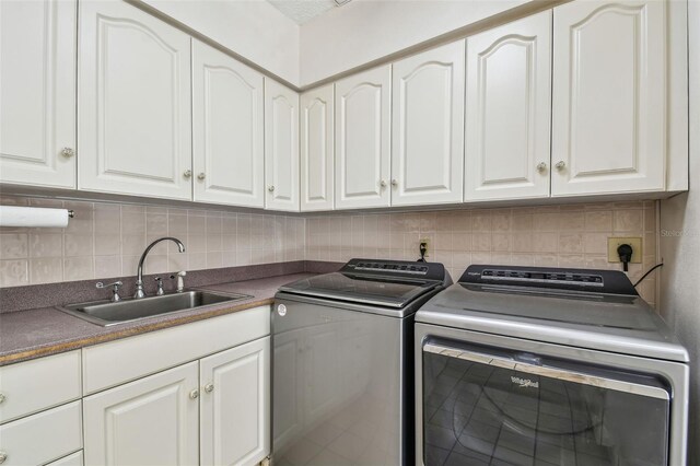 laundry room with a sink, cabinet space, and washing machine and clothes dryer