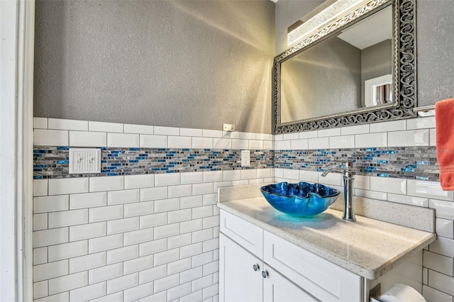bathroom with vanity, tile walls, and a textured wall