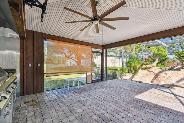 unfurnished sunroom featuring a ceiling fan
