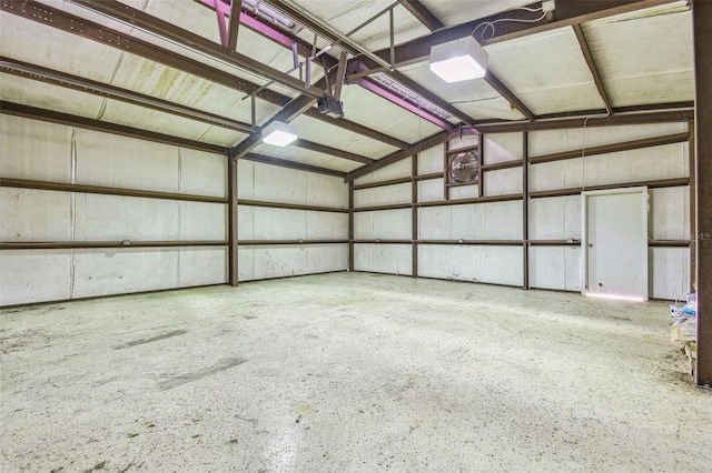 garage featuring a garage door opener and metal wall