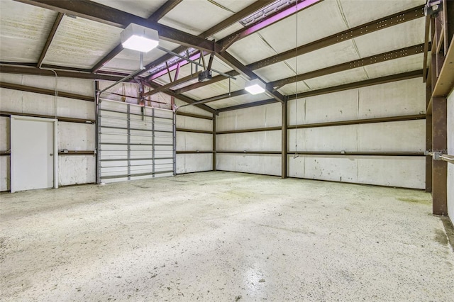 garage with a garage door opener and metal wall