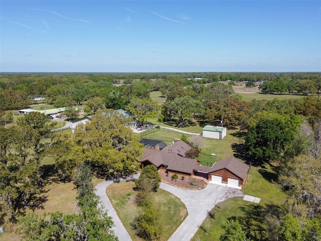 birds eye view of property with a view of trees