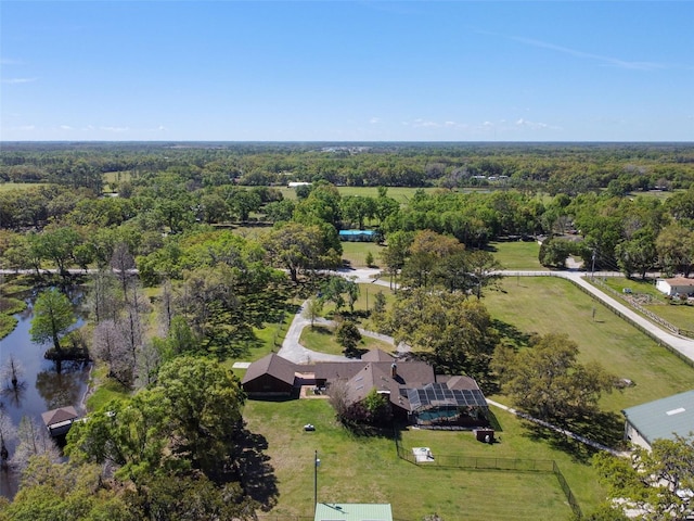 drone / aerial view featuring a wooded view