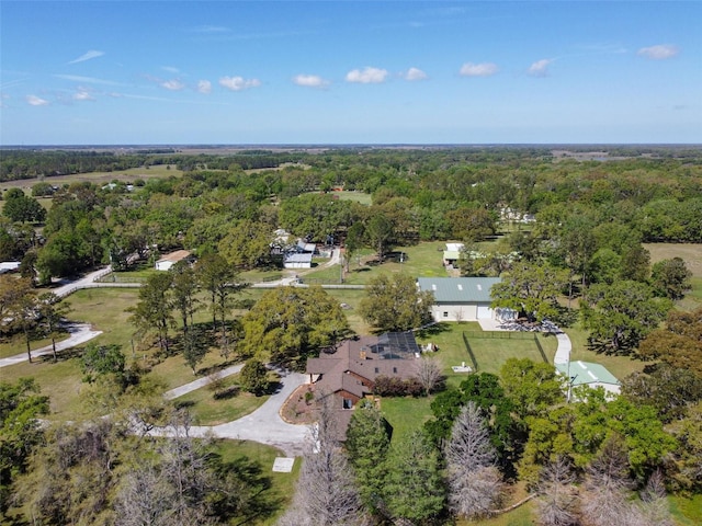 birds eye view of property with a wooded view