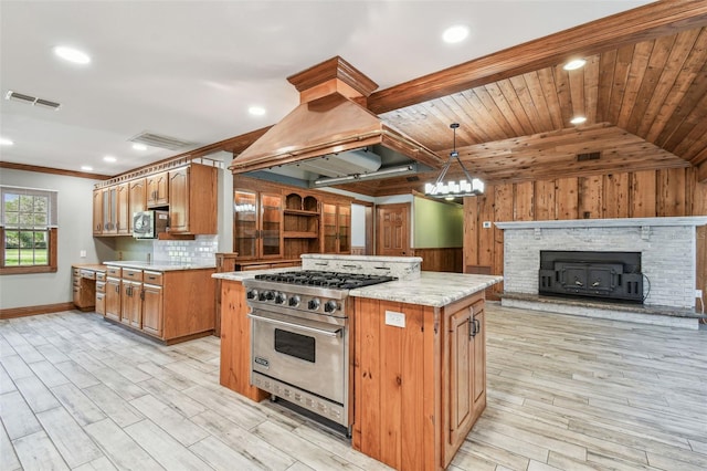 kitchen with stainless steel appliances, backsplash, visible vents, and island range hood
