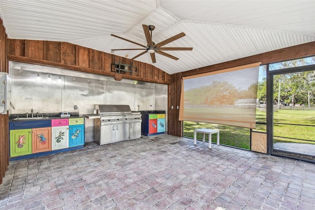 unfurnished sunroom with an outdoor kitchen, a healthy amount of sunlight, ceiling fan, and a sink