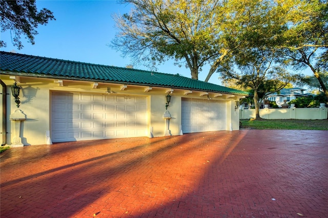 detached garage featuring fence