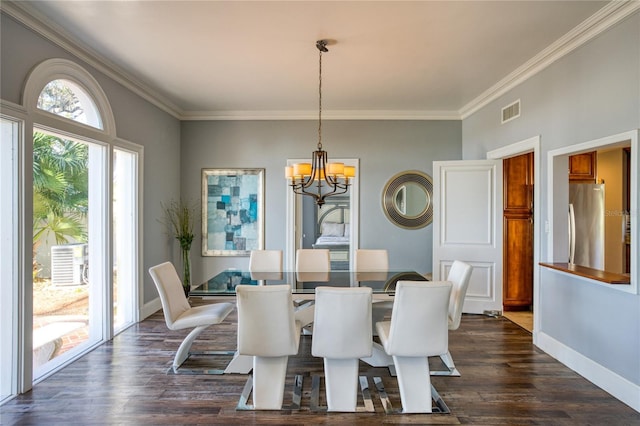 dining area featuring baseboards, visible vents, an inviting chandelier, dark wood-style flooring, and ornamental molding