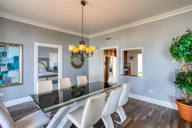 dining room with visible vents, a notable chandelier, ornamental molding, dark wood finished floors, and baseboards