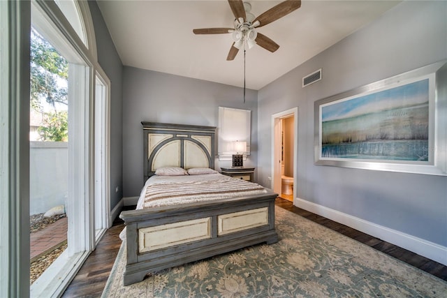 bedroom featuring dark wood-style floors, baseboards, visible vents, and ceiling fan