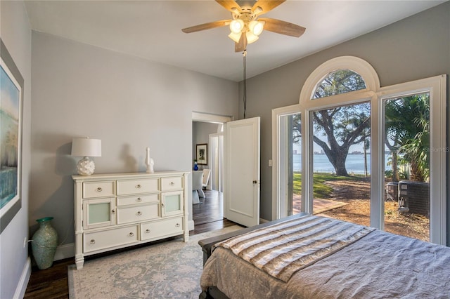 bedroom featuring a ceiling fan, baseboards, and wood finished floors