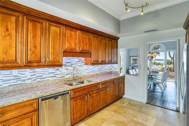 kitchen with visible vents, crown molding, decorative backsplash, stainless steel appliances, and a sink