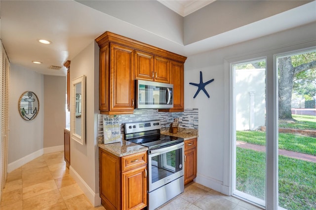 kitchen with visible vents, light stone counters, tasteful backsplash, appliances with stainless steel finishes, and brown cabinetry