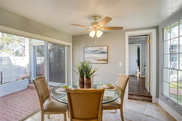 sunroom / solarium with a healthy amount of sunlight and a ceiling fan