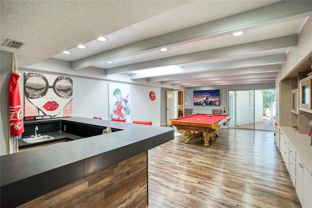 game room with billiards, wood finished floors, wet bar, beam ceiling, and a sink