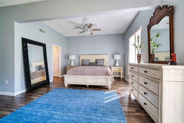 bedroom featuring dark wood-type flooring, baseboards, visible vents, and a textured ceiling