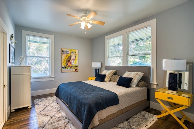 bedroom with baseboards, wood finished floors, and a ceiling fan