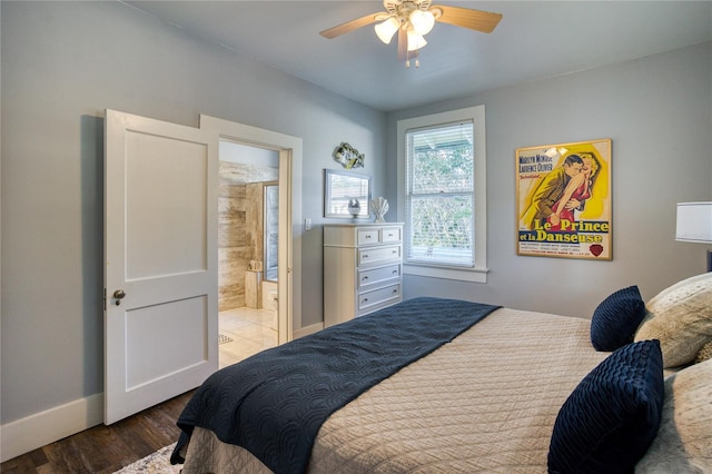 bedroom featuring connected bathroom, ceiling fan, baseboards, and wood finished floors