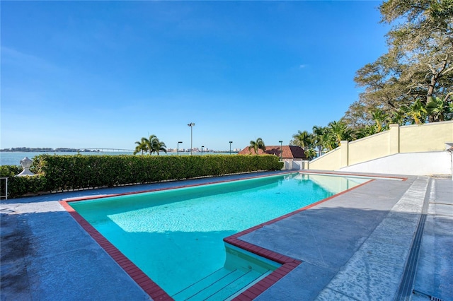 view of pool featuring a fenced in pool, a patio area, and fence