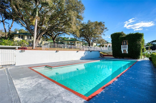 view of swimming pool with fence and a fenced in pool