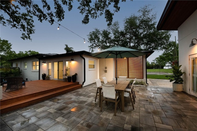 view of patio / terrace featuring a wooden deck and outdoor dining space