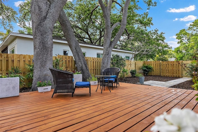 wooden terrace featuring fence