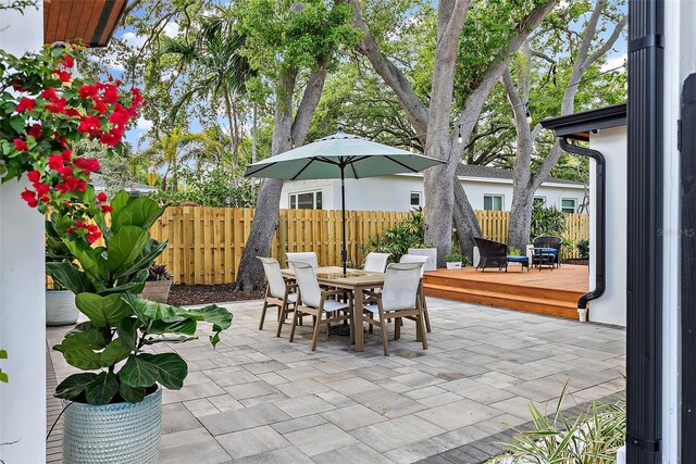 view of patio / terrace with a wooden deck, fence, and outdoor dining space