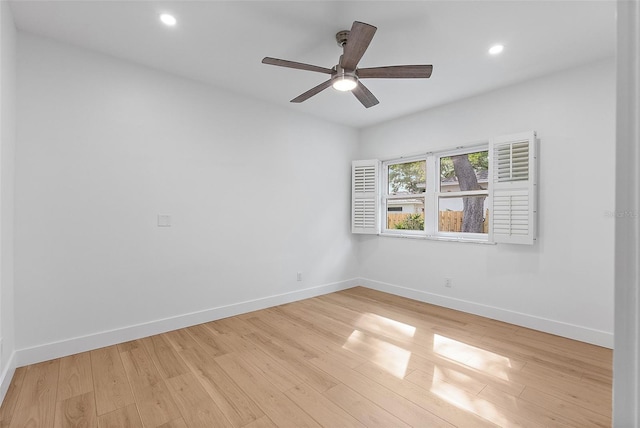spare room featuring baseboards, wood finished floors, recessed lighting, and a ceiling fan
