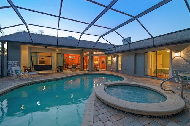 view of pool with a patio area, a lanai, and a pool with connected hot tub