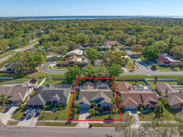 birds eye view of property featuring a residential view and a wooded view